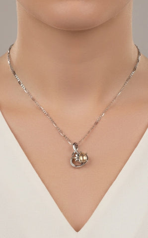 Silver necklace with a heart-shaped pendant on a mannequin
